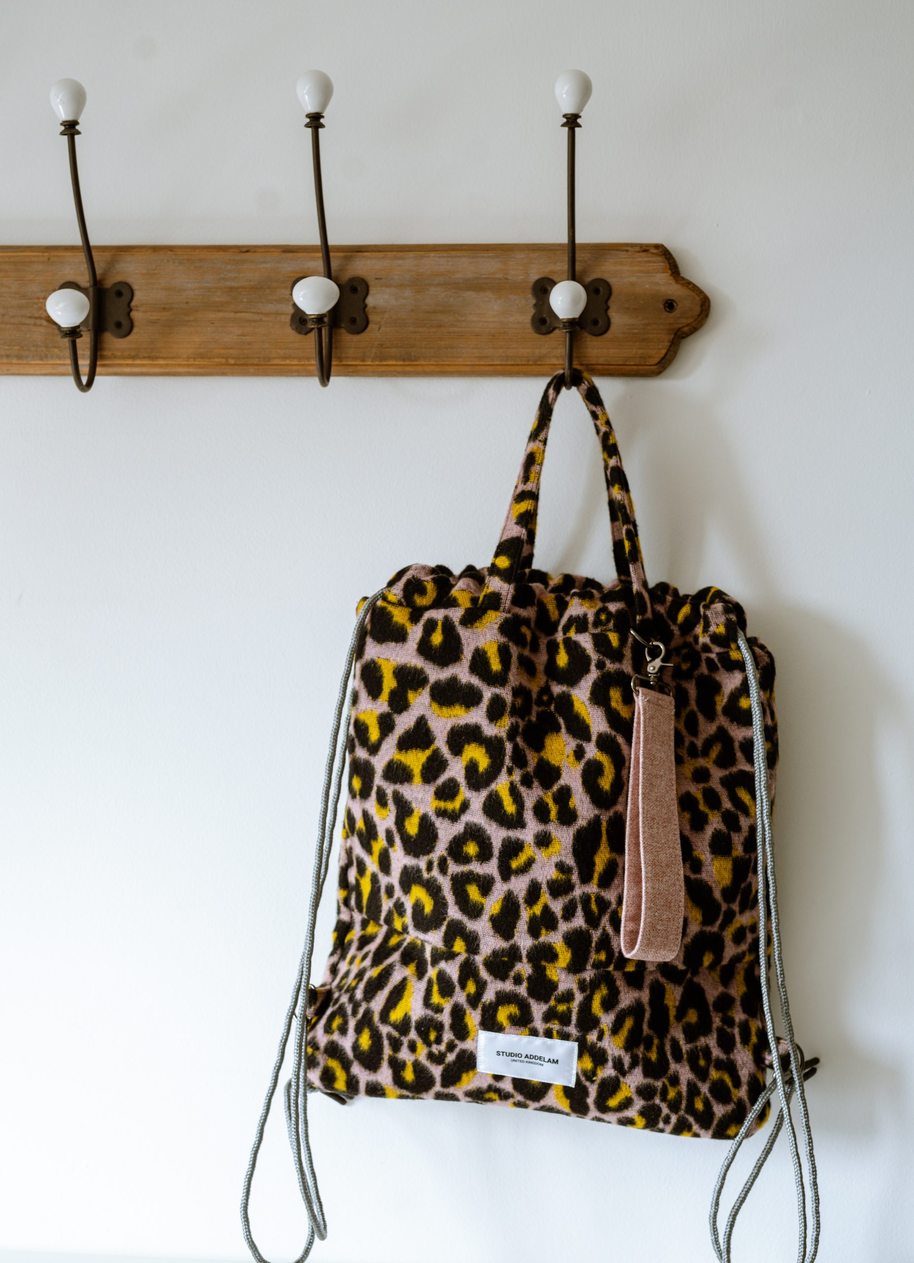 Animal print bag hanging from a coat peg